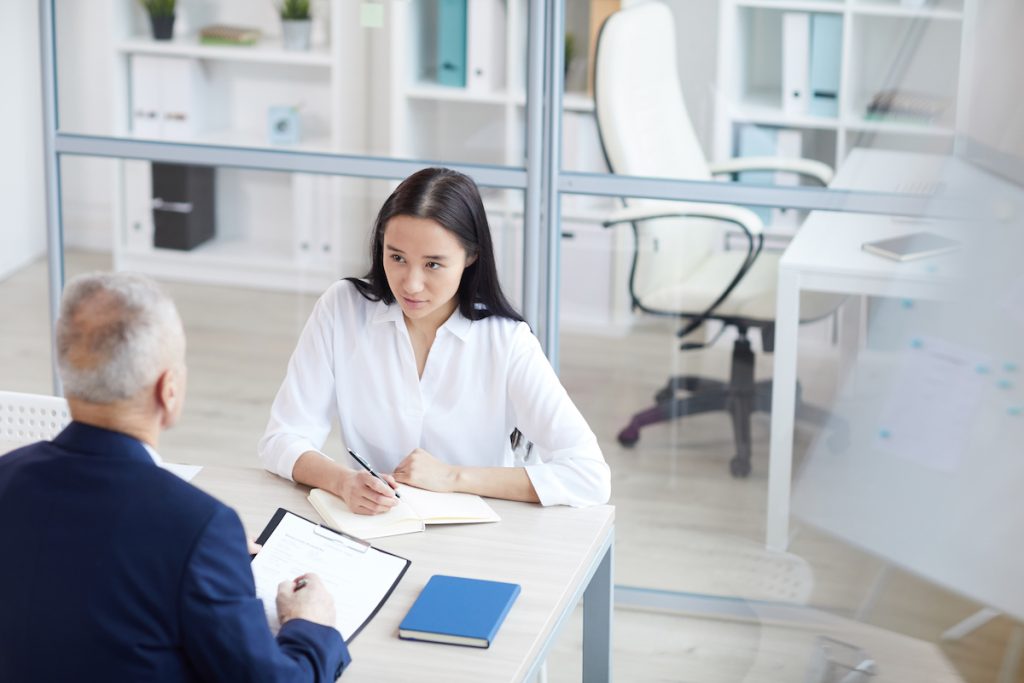 woman asking field technician questions in interview with man