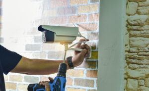 Technician installing CCTV camera for security