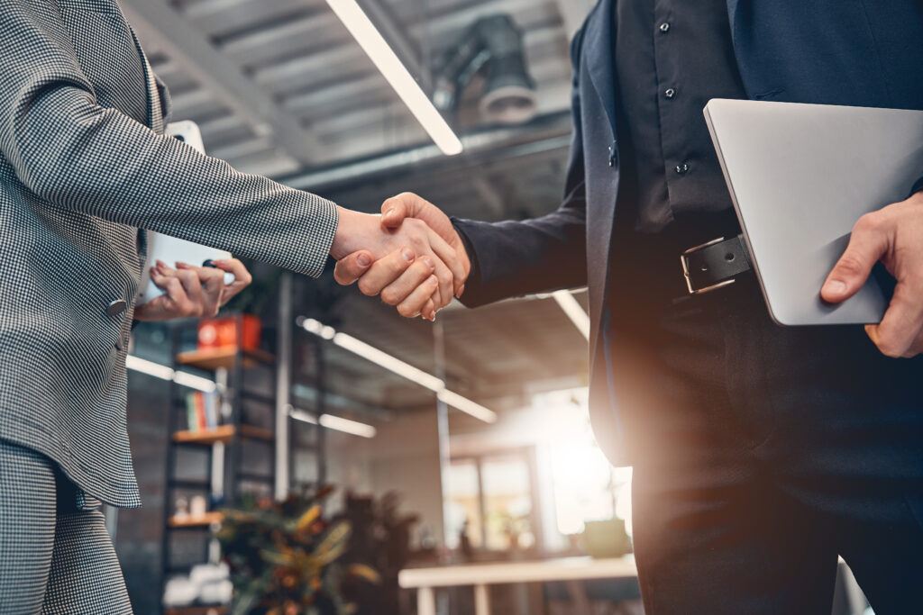 Business partner shaking hand in the modern office