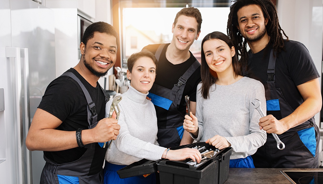 appliance repair business team standing in a kitchen