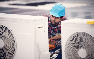 Facilities maintenance contractor inspecting commercial hvac units