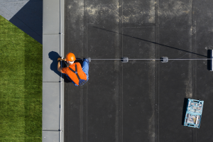 Facility management technician maintaining equipment on rooftop
