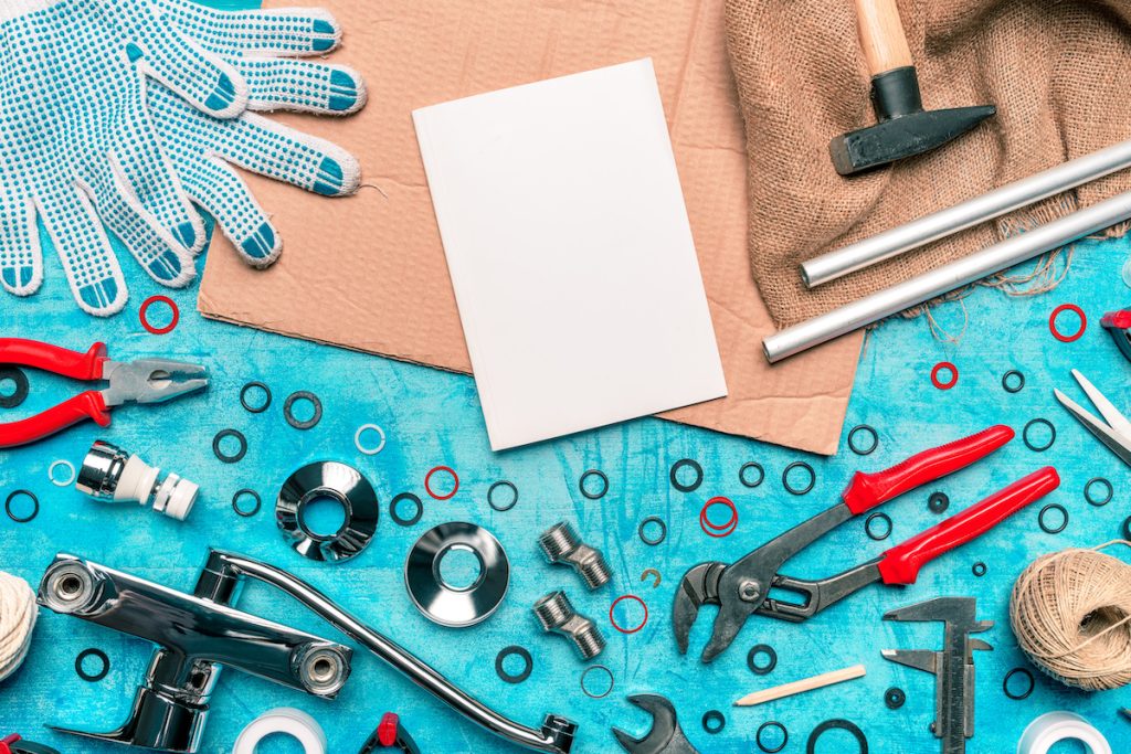 essential plumbing tools laid out on a table