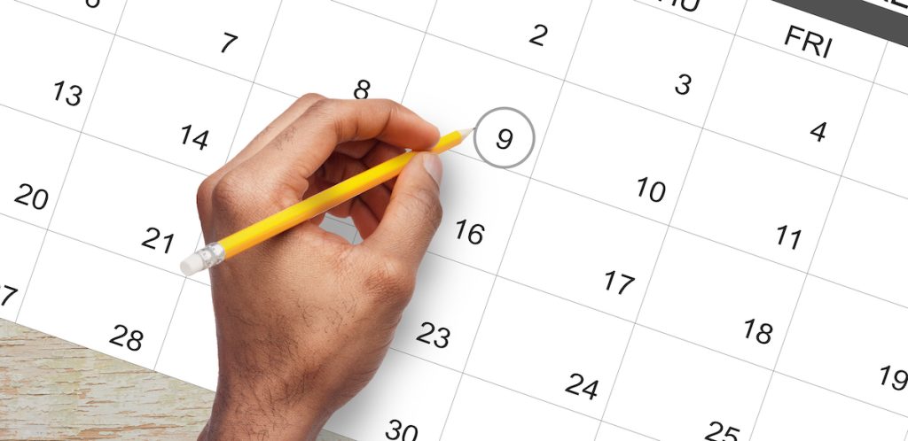 hand writing a date for an automated appointment reminder